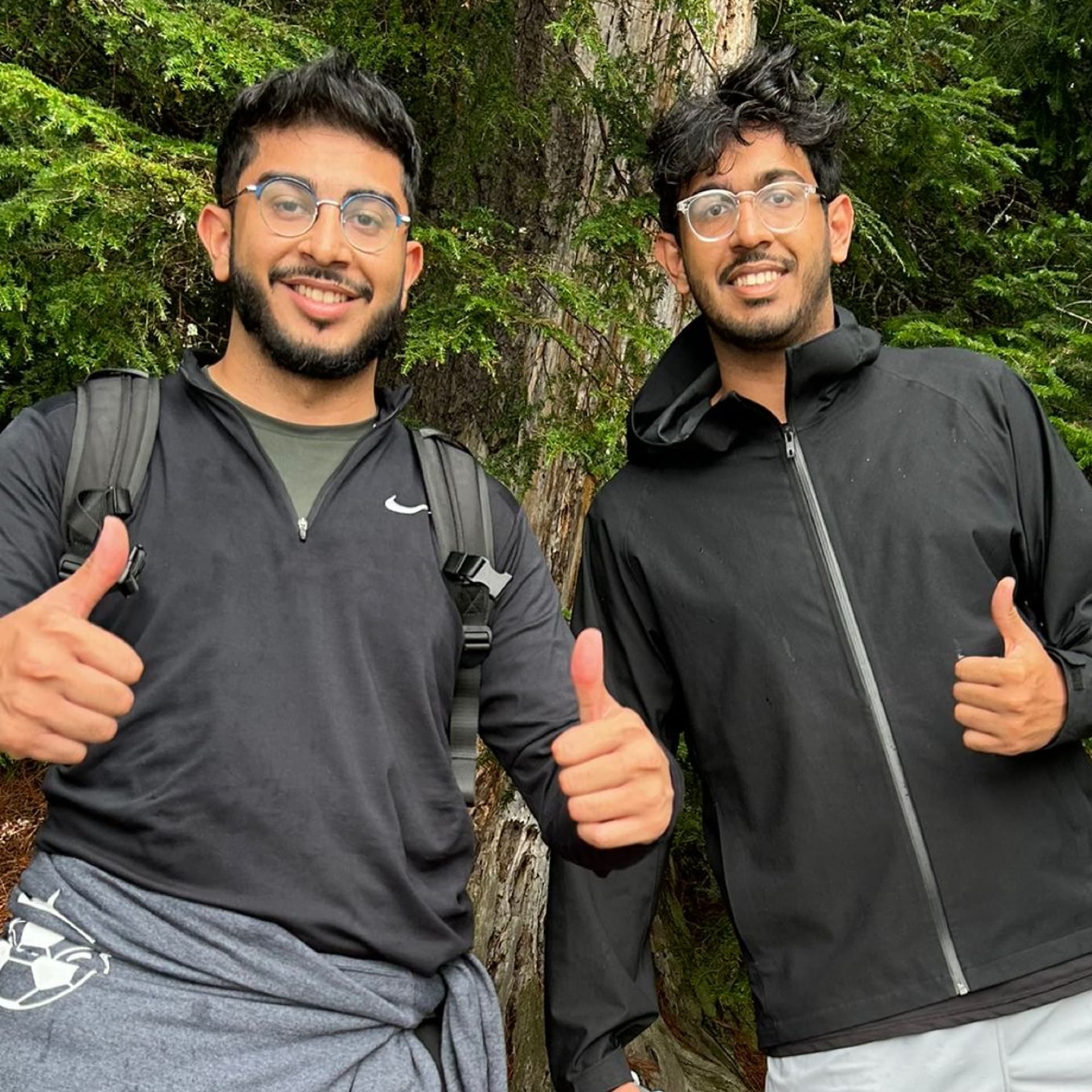 Kuro founders Mohammed and Jahangir giving thumbs up on a forest trail